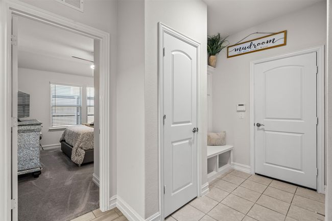 Mudroom featuring light tile patterned floors, baseboards, and visible vents | Image 10