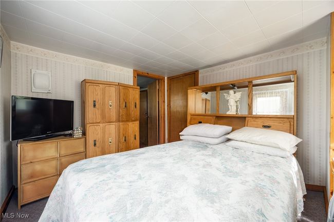 Carpeted bedroom featuring wallpapered walls | Image 19