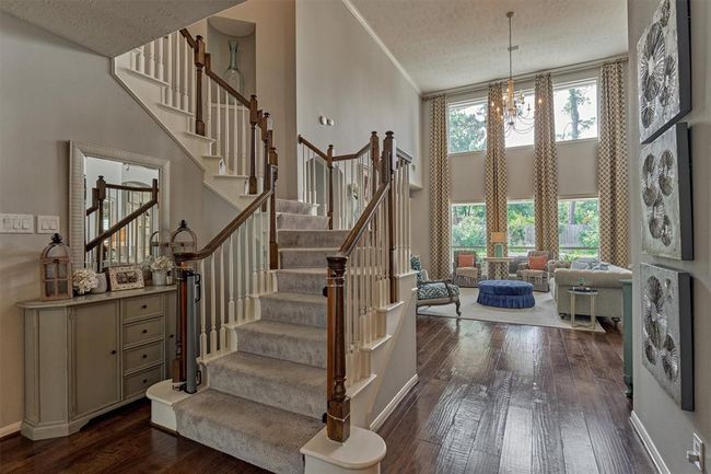 From the entry you are greeted with staircase and your first sight of this picturesque Family Room complete with two story-windows, tasteful lighting and gas log fireplace. | Image 9