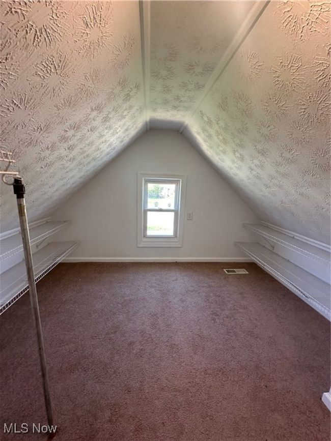 Bonus room with a textured ceiling, visible vents, baseboards, vaulted ceiling, and carpet | Image 30