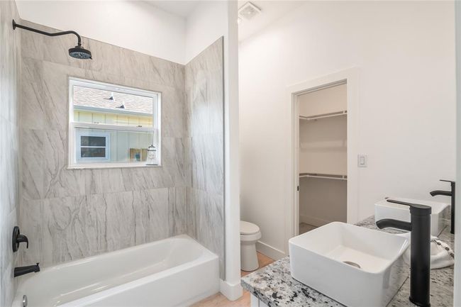 Spacious secondary bath with elegant double sinks. | Image 13