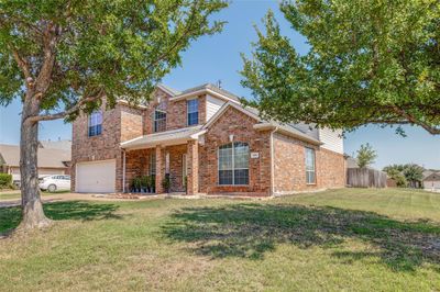 View of front property with a front yard and a garage | Image 1