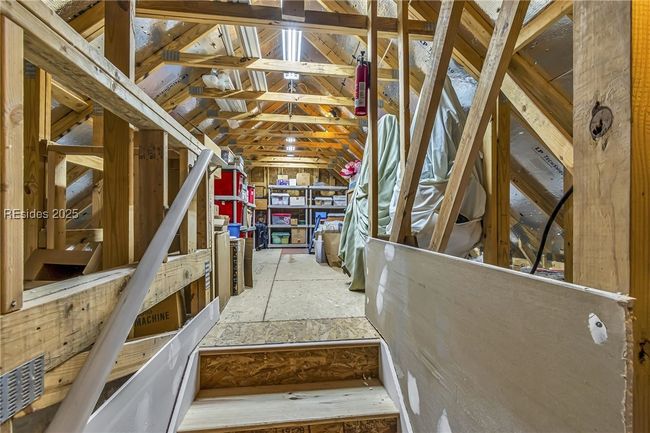 Floored walk in upstairs attic above garage | Image 34