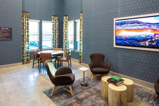 Living area with concrete flooring and tile walls | Image 10