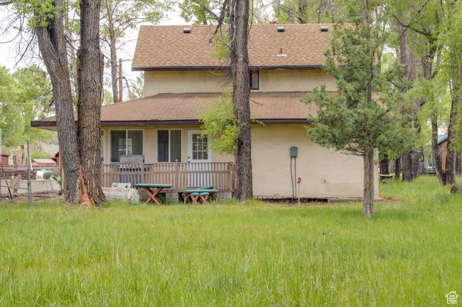 Back of house featuring stucco siding and roof with shingles | Image 8