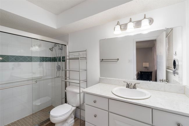 Full bath featuring vanity, a shower stall, toilet, and a textured ceiling | Image 22