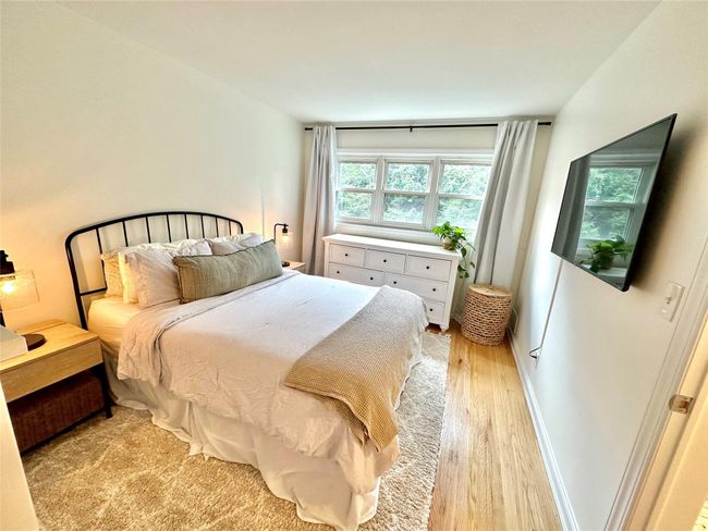 Bedroom with light wood finished floors | Image 15