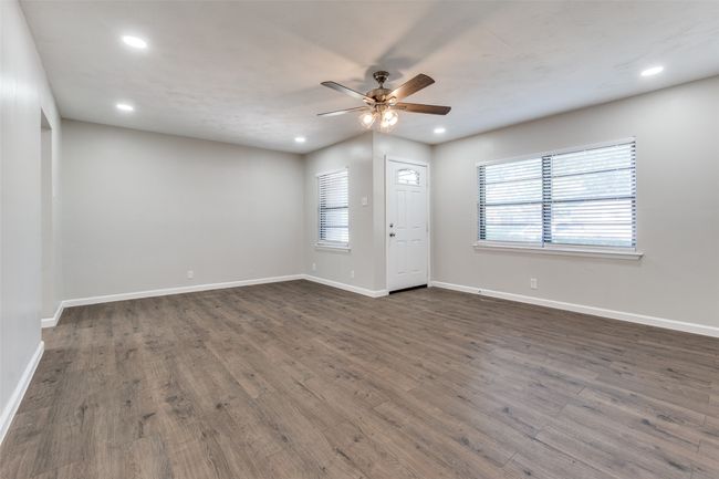 Unfurnished room featuring ceiling fan, dark wood-style floors, and recessed lighting | Image 4