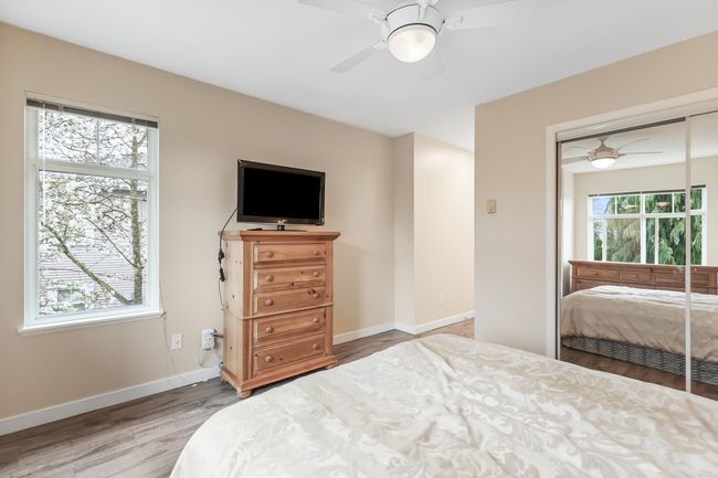 Bedroom with a closet, baseboards, ceiling fan, and wood finished floors | Image 20