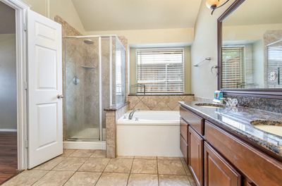 Bathroom with plus walk in shower, tile patterned floors, lofted ceiling, and double vanity | Image 3