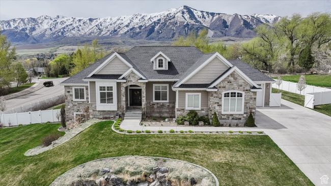 View of front of property with driveway, stone siding, a front lawn, and a mountain view | Image 10
