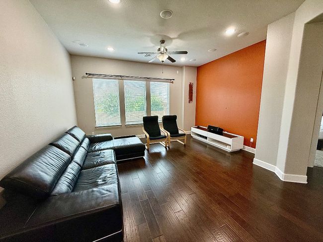 Living room with a ceiling fan, hardwood / wood-style flooring, recessed lighting, and baseboards | Image 7