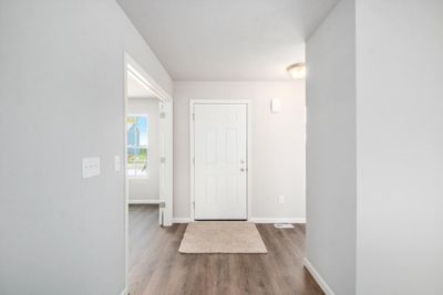 Large foyer entrance opens to a den with French doors | Image 2