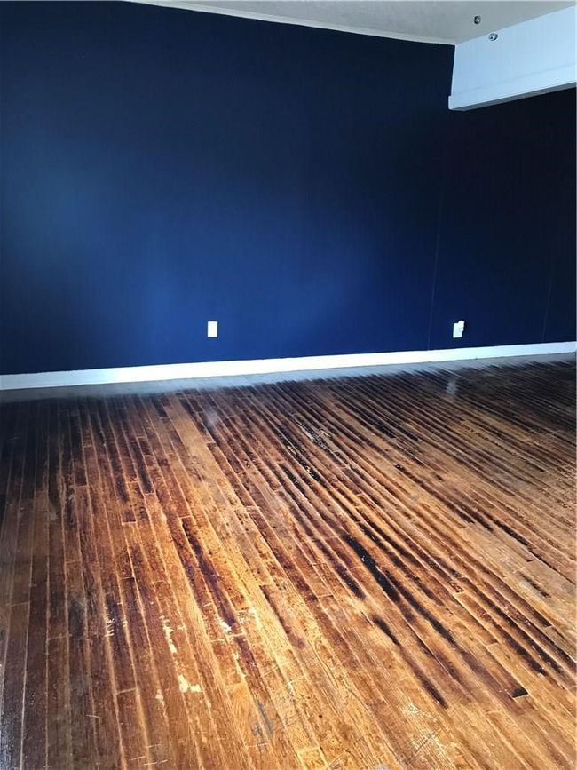 Empty room featuring wood-type flooring and baseboards | Image 5