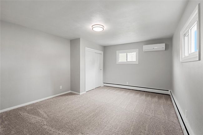 First floor primary bedroom with double closet. This room offers a mini split for AC. Fresh paint and new carpet! | Image 12
