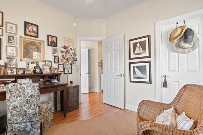 Living area with a ceiling fan, baseboards, and light wood-type flooring | Image 5