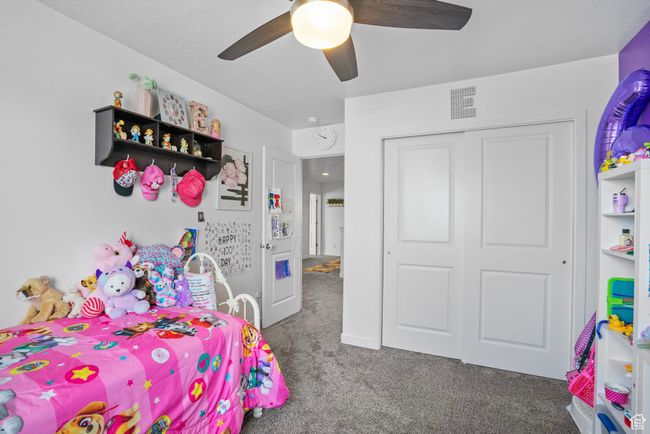Bedroom featuring carpet, a closet, a ceiling fan, and visible vents | Image 18