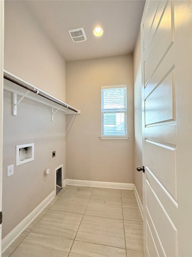 Laundry area featuring hookup for an electric dryer, washer hookup, gas dryer hookup, and recessed lighting | Image 25