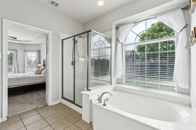 Primary ensuite bathroom with a garden tub, tile flooring, separate shower, and two vanities | Image 21