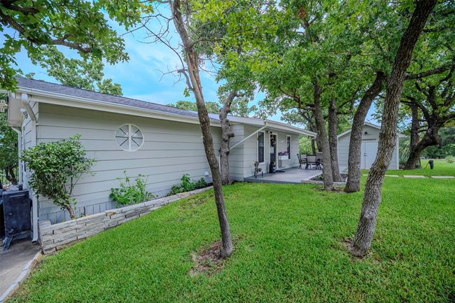View of front facade featuring a patio, a front lawn, and an outbuilding | Image 4