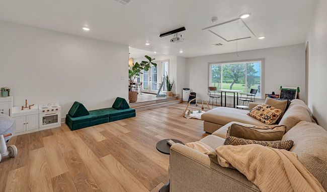Living area featuring attic access, recessed lighting, and light wood-style flooring | Image 21
