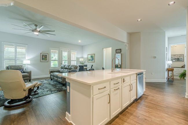 Kitchen featuring open floor plan, a sink, wood finished floors, recessed lighting, and baseboards | Image 16