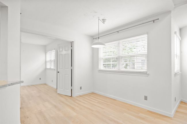 Unfurnished dining area featuring light wood finished floors and baseboards | Image 8