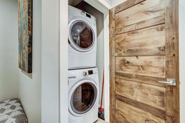 Laundry area featuring stacked washing maching and dryer and laundry area | Image 37