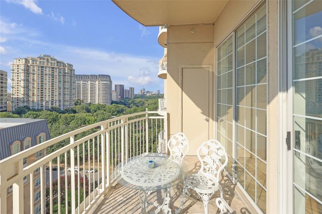 Balcony featuring a view of city and view of scattered trees | Image 18