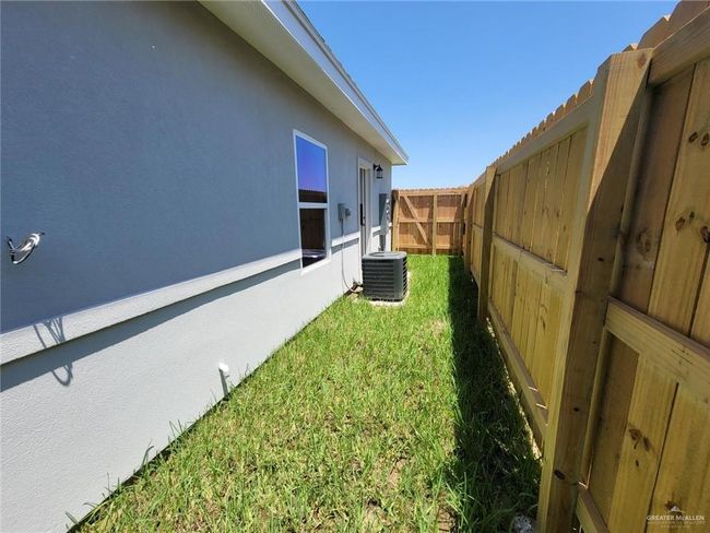 View of fenced backyard | Image 19