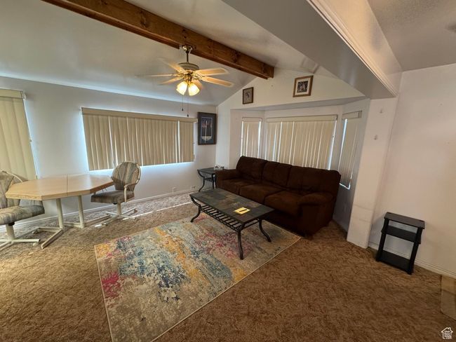 Carpeted living room with a ceiling fan and baseboards | Image 4