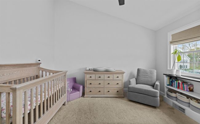 Carpeted bedroom with lofted ceiling, a ceiling fan, and a nursery area | Image 18