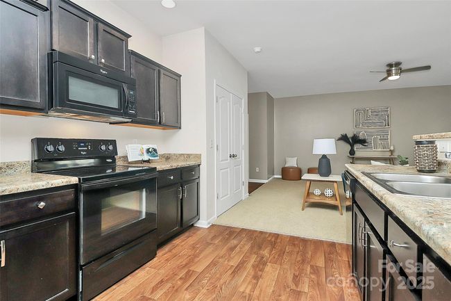 Open dining/kitchen area with transition bar suitable for plenty of guests. | Image 9