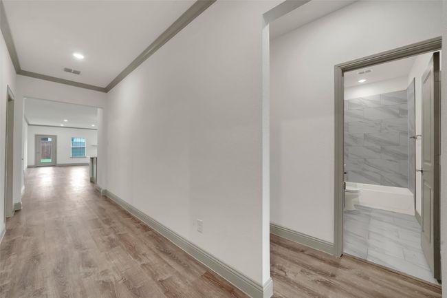 Corridor featuring visible vents, baseboards, crown molding, recessed lighting, and light wood-style flooring | Image 5