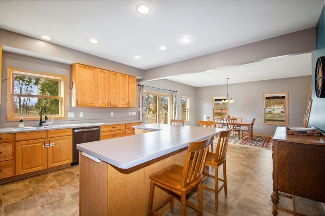 The large center island is perfect with bar stools for everyone to gather around the heart of them home! | Image 4