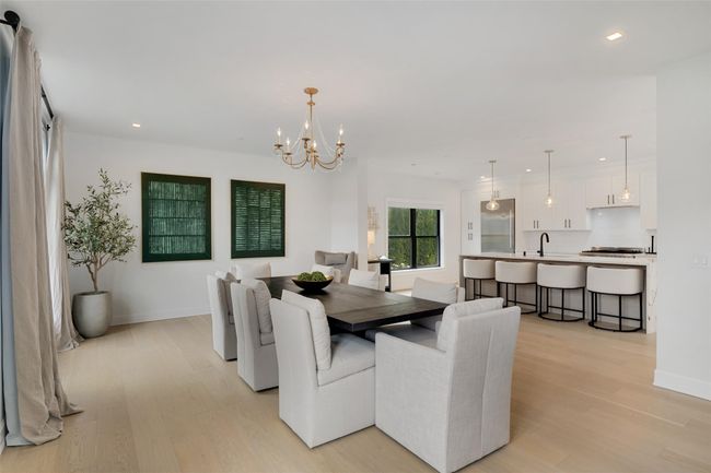 Dining area with a chandelier, light wood-type flooring, baseboards, and recessed lighting | Image 8