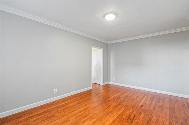 Empty room featuring light hardwood / wood-style flooring and ornamental molding | Image 6