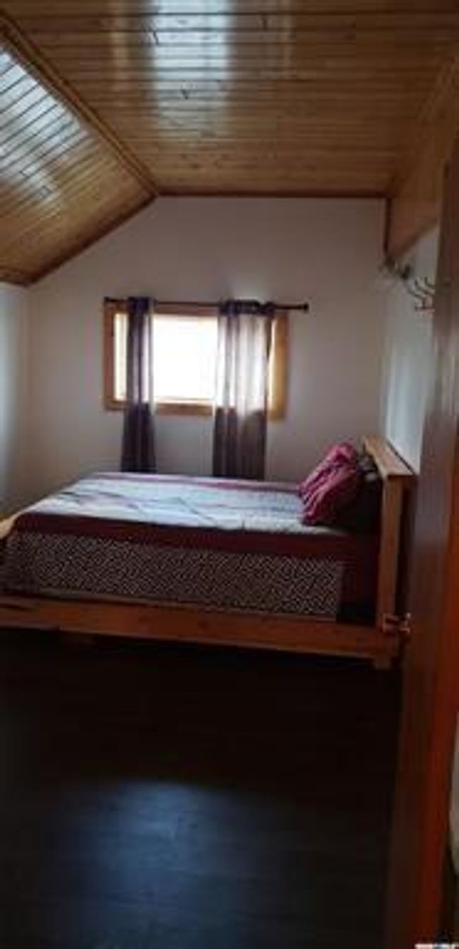 Unfurnished bedroom featuring wood ceiling and vaulted ceiling | Image 11