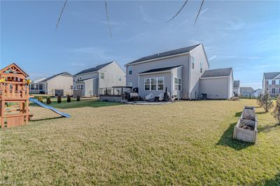 View of yard with a playground and a wooden deck | Image 3