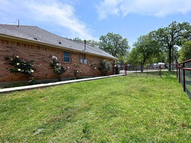 Landscaped yard with sidewalk to spacious patio | Image 26