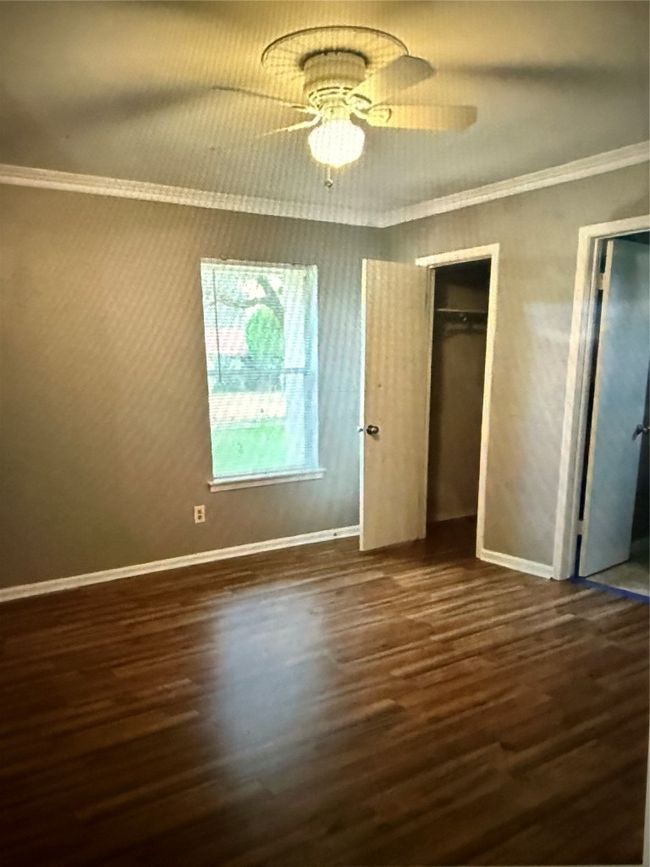 Primary bedroom featuring wood finished floors, ornamental molding, and ceiling fan | Image 13