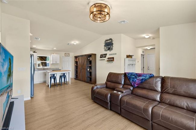 Living room featuring visible vents, vaulted ceiling, and light wood-style floors | Image 5