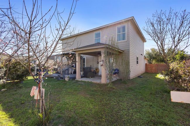 Rear view of house with a patio, a pergola, fence, and a lawn | Image 33