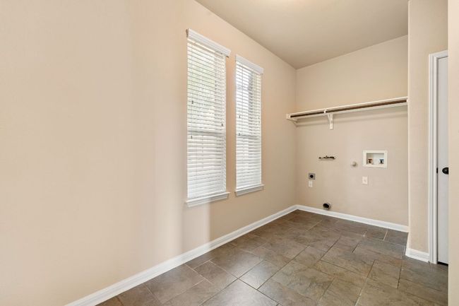 Large laundry room tucked behind the formal dining/kitchen | Image 29