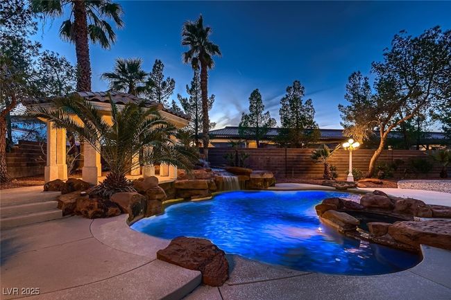 View of swimming pool featuring a fenced in pool, a patio area, and a fenced backyard | Image 8
