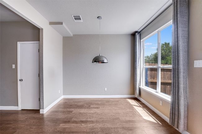 Empty room featuring wood finished floors and baseboards | Image 8