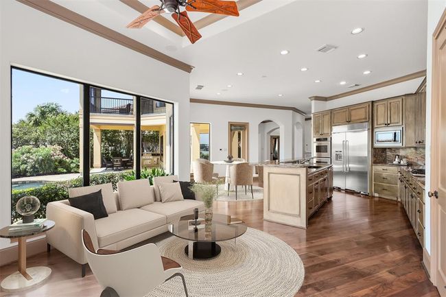 Bathed in natural light, this elegant sunroom is designed with the discerning waterfront buyer in mind. Relax and visit with the chef. Virtually staged. | Image 20