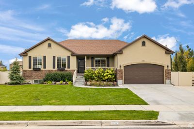 View of front facade with a front yard and a garage | Image 1