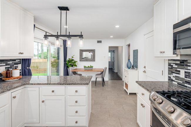 View looking from the kitchen into the dining area. | Image 16