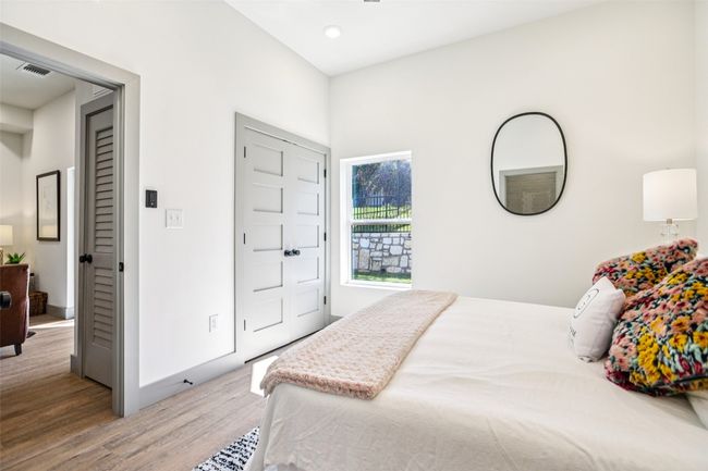 Bedroom featuring light wood-style floors and baseboards | Image 17